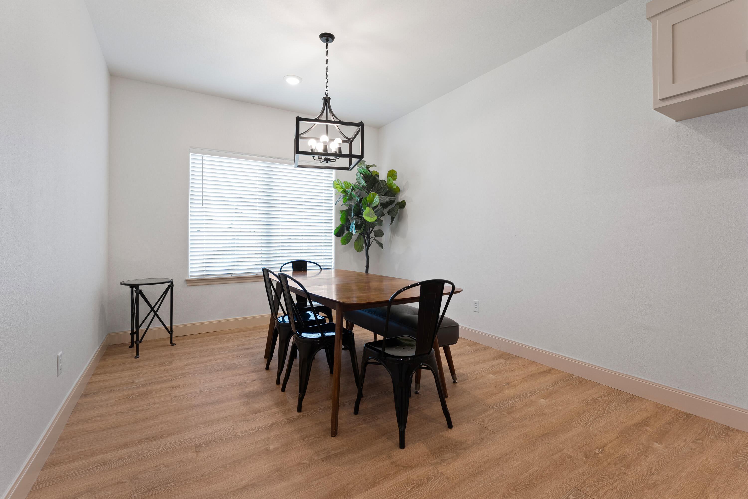 5516 120th Street Lubbock, TX 79424 - Photo 13 of 30 a view of a dining room with furniture window and wooden floor