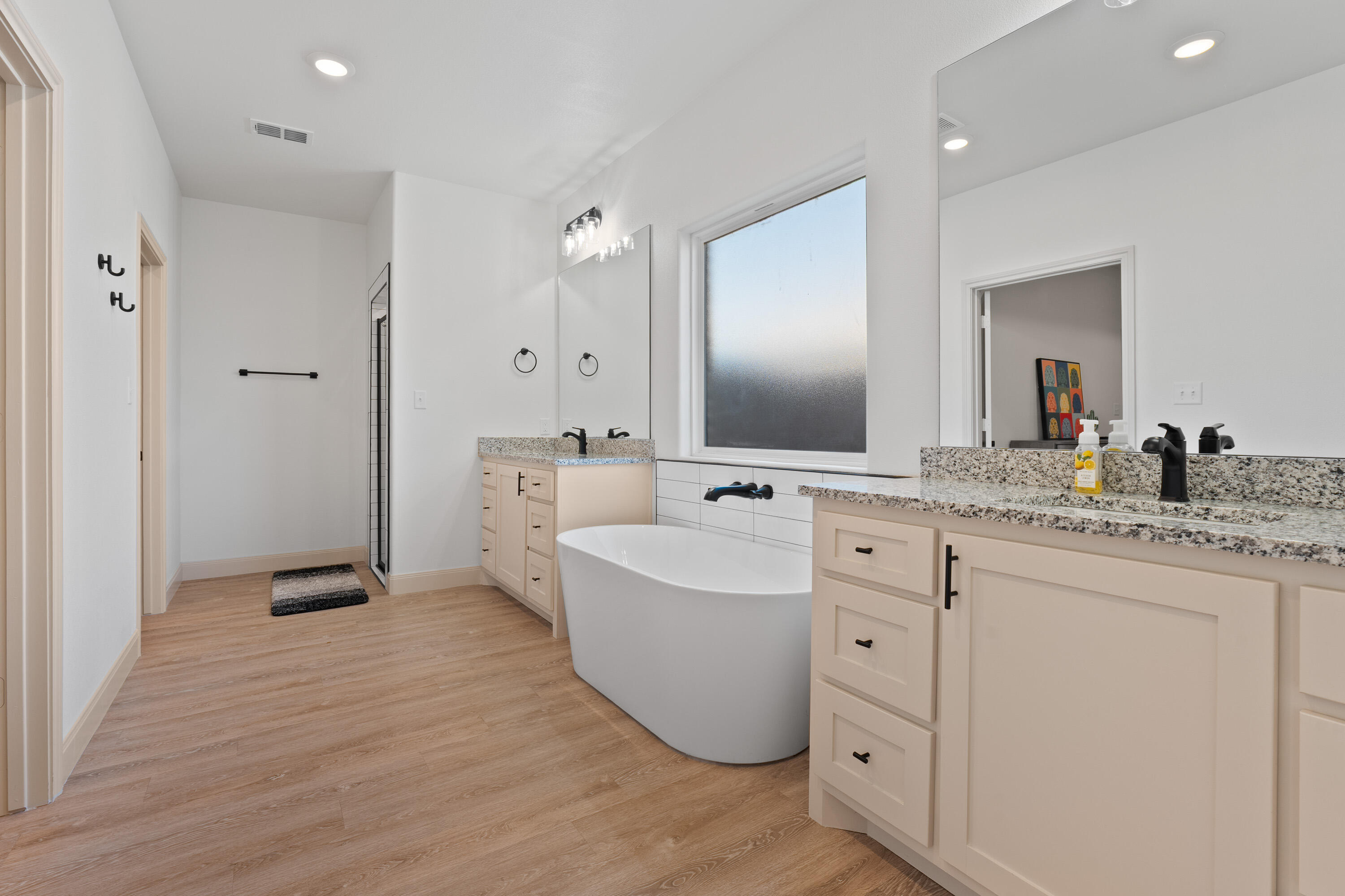 5516 120th Street Lubbock, TX 79424 - Photo 17 of 30 a spacious bathroom with a double vanity sink mirror and bathtub