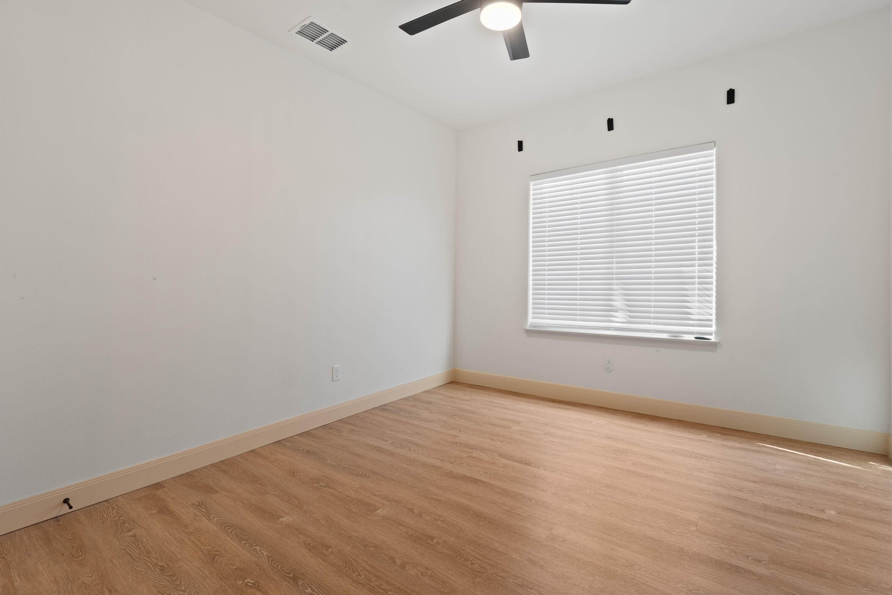 5516 120th Street Lubbock, TX 79424 - Photo 20 of 30 an empty room with a window and ceiling fan