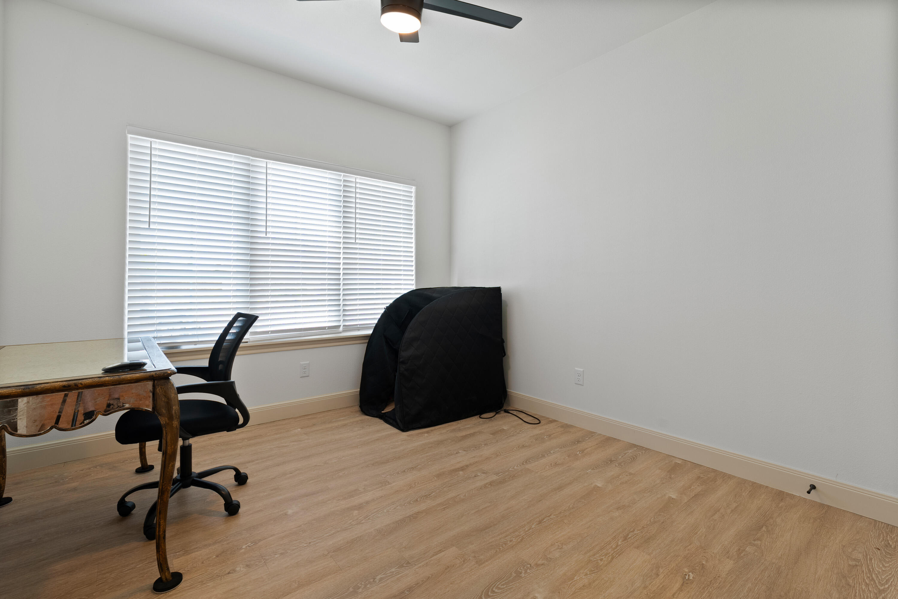 5516 120th Street Lubbock, TX 79424 - Photo 23 of 30 a view of a workspace with furniture and a window