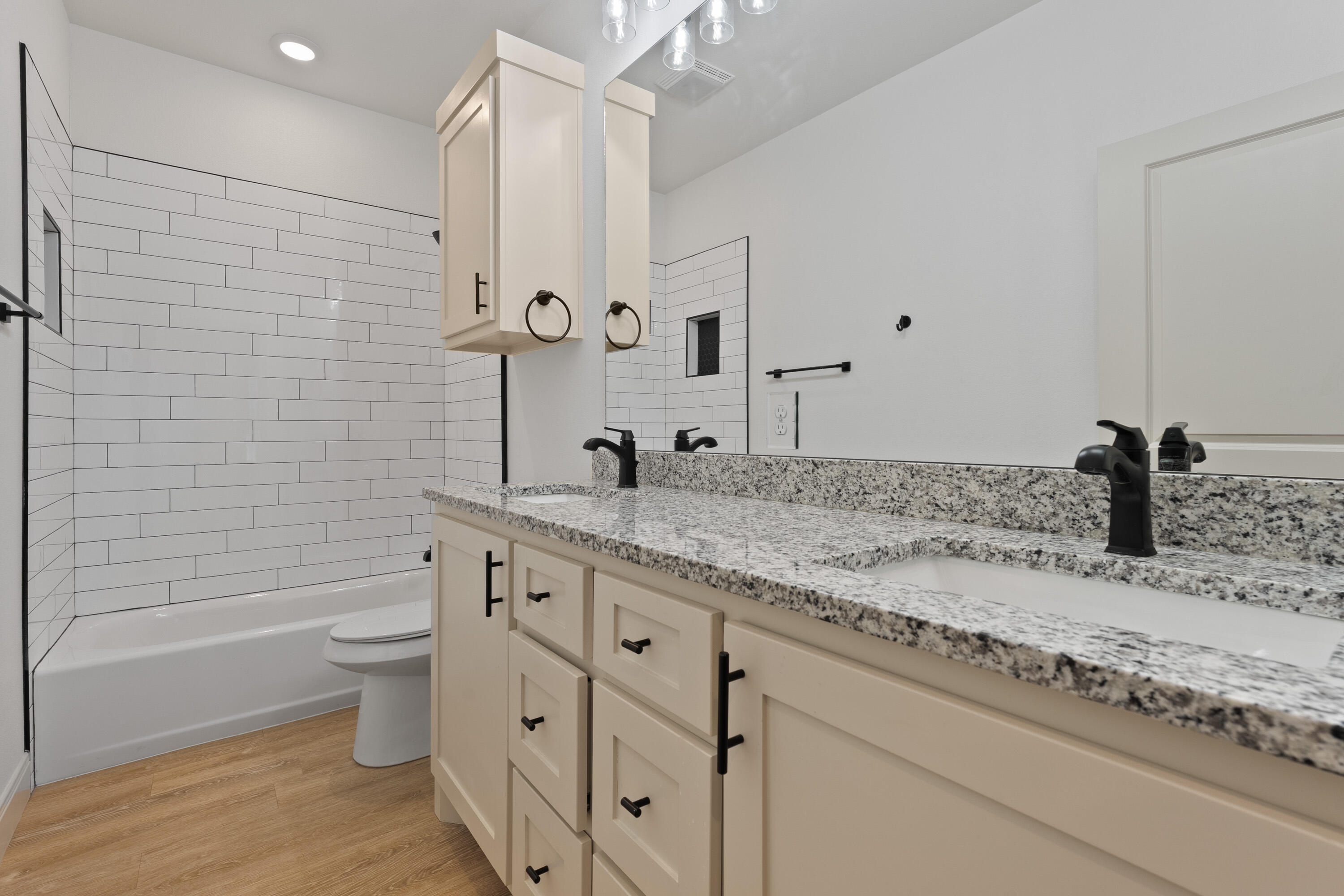 5516 120th Street Lubbock, TX 79424 - Photo 25 of 34 a bathroom with a granite countertop sink a toilet and shower