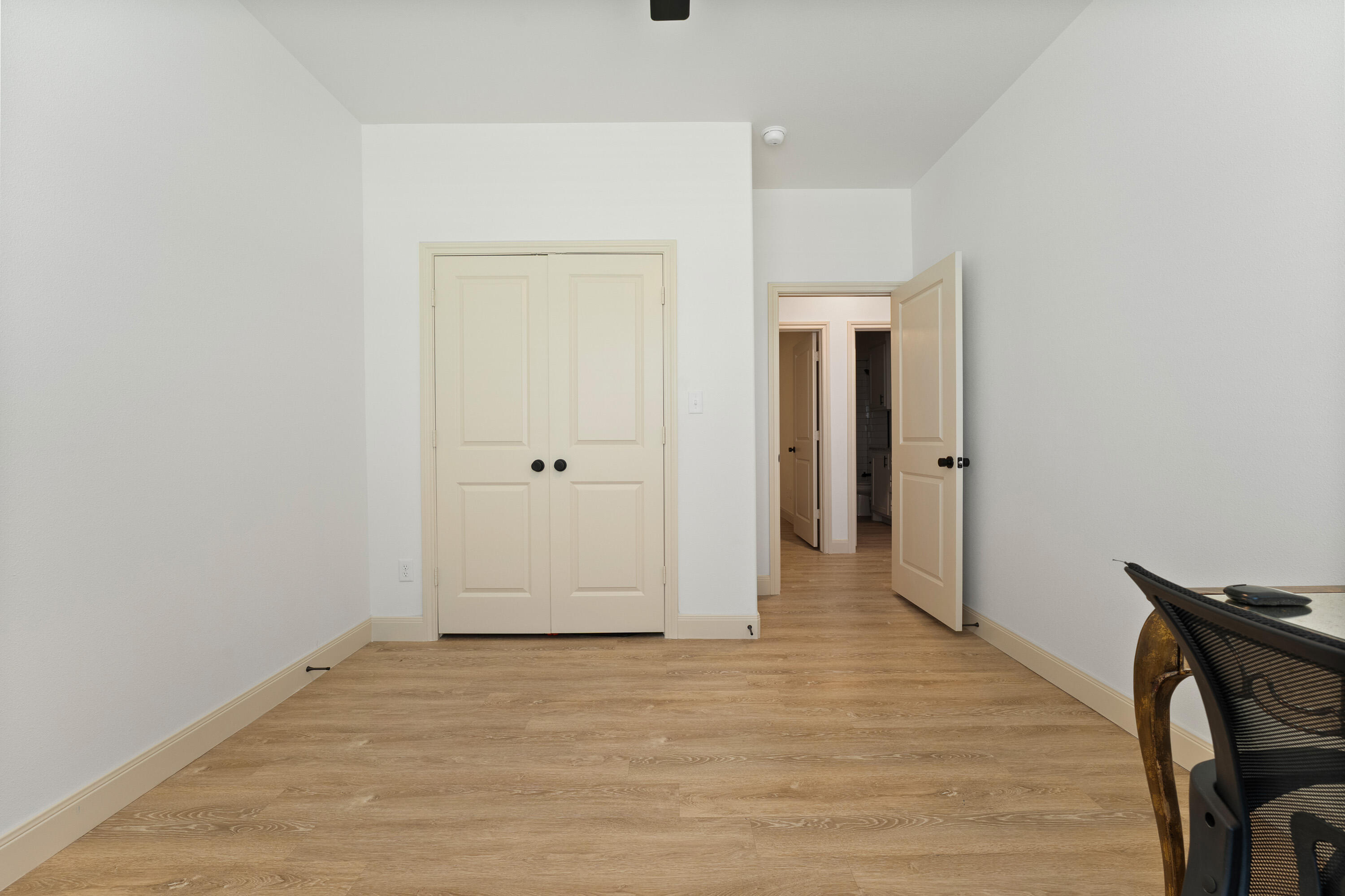 5516 120th Street Lubbock, TX 79424 - Photo 27 of 34 an empty room with wooden floor and closet
