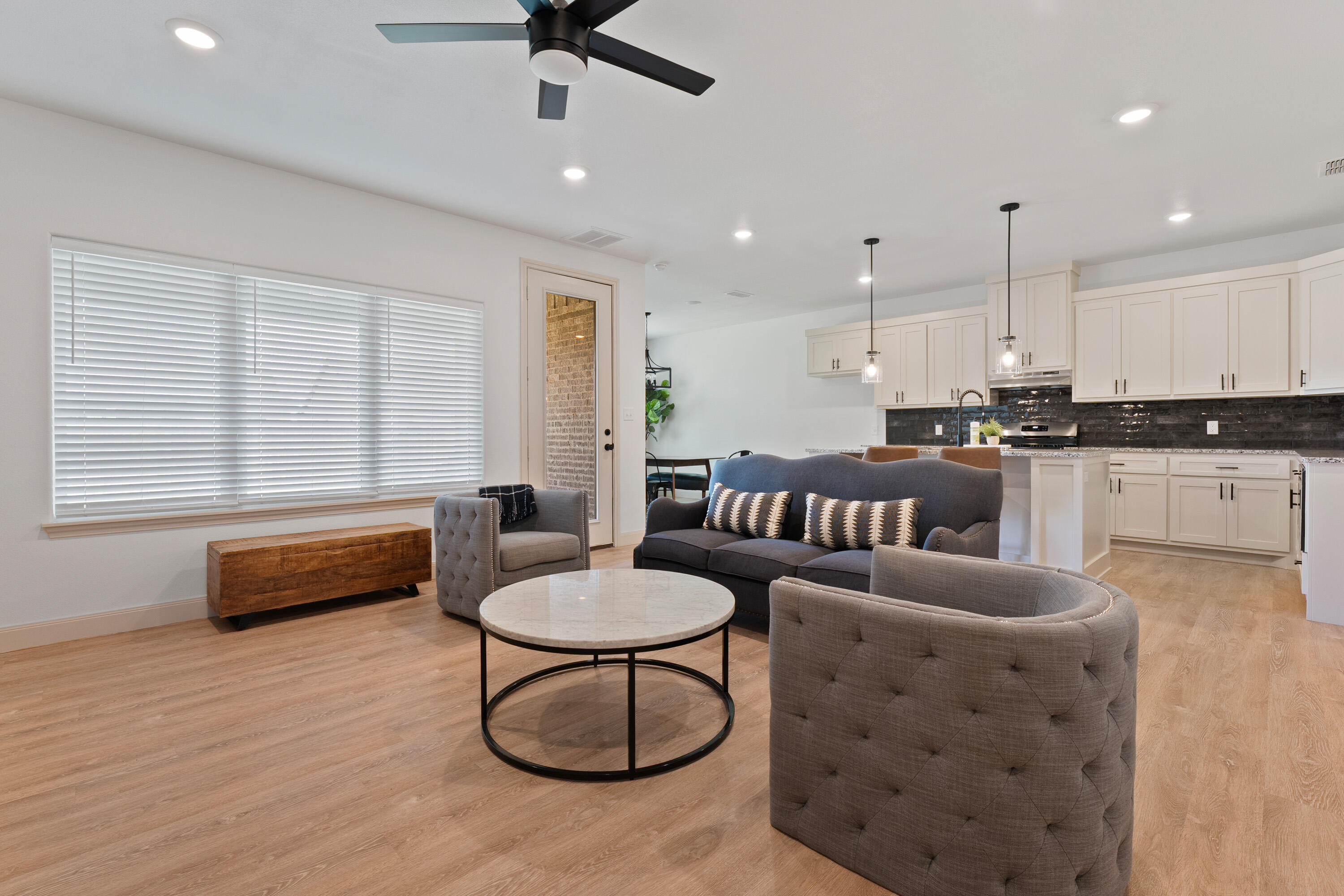 5516 120th Street Lubbock, TX 79424 - Photo 6 of 34 a living room with furniture and kitchen view