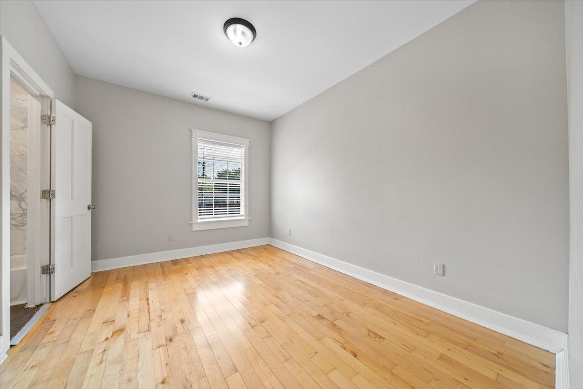 196 North McNeil Street Memphis, TN 38112 - Photo 14 of 31 a view of an empty room with wooden floor and a window