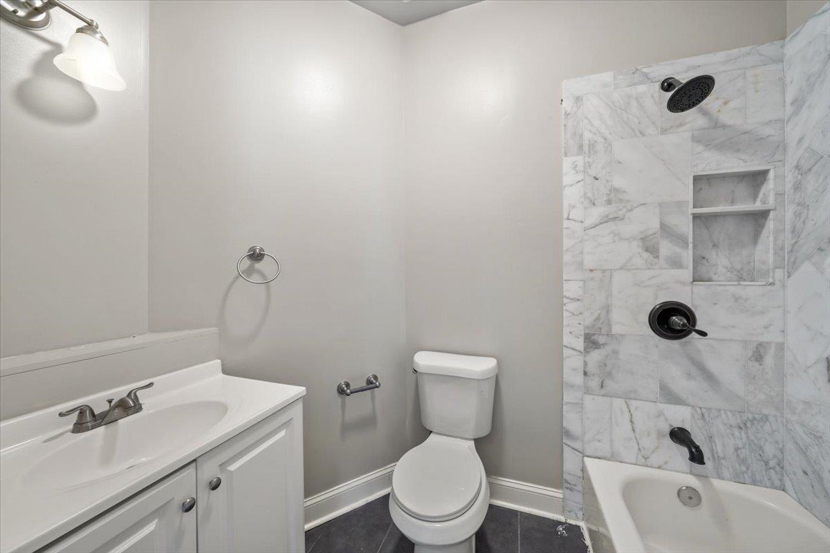 196 North McNeil Street Memphis, TN 38112 - Photo 15 of 31 a bathroom with a sink toilet and shower
