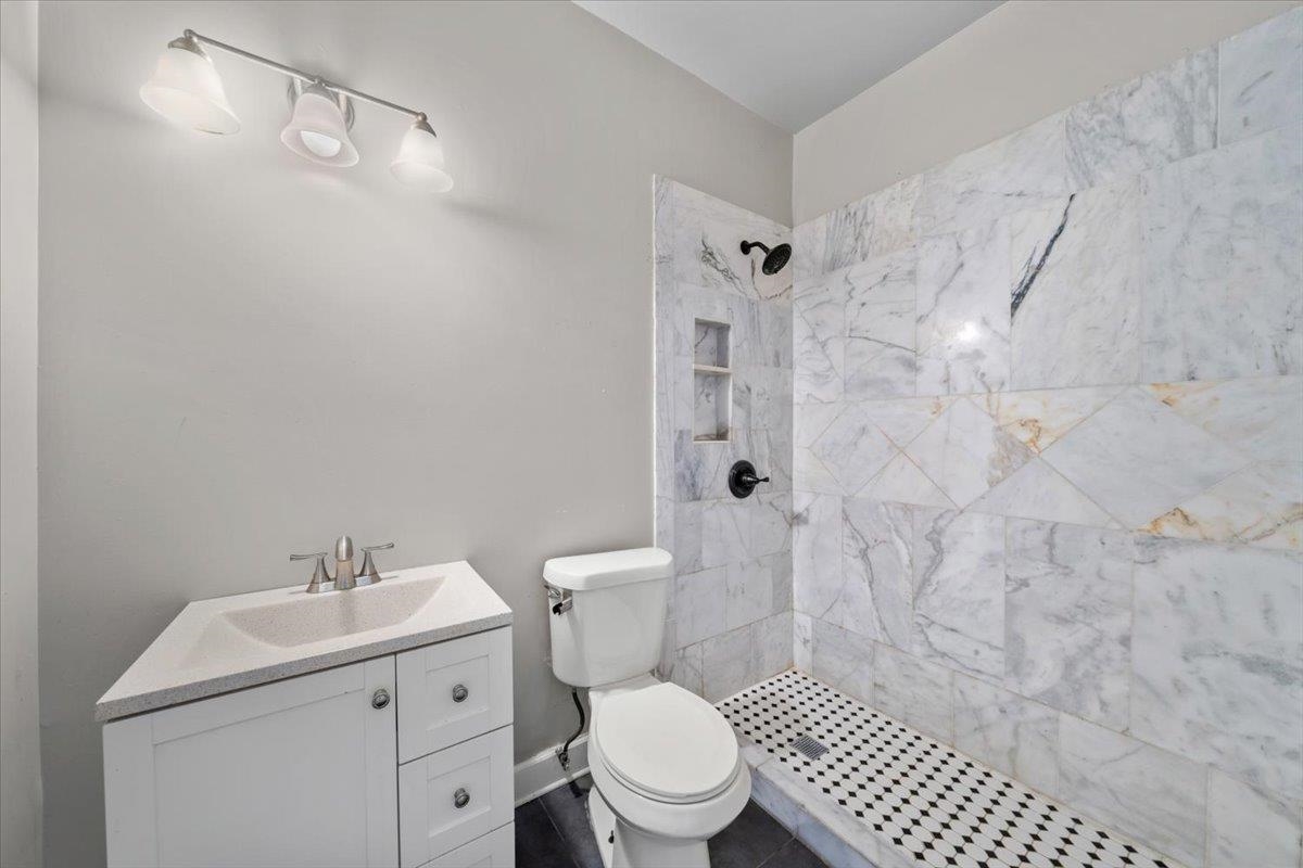 196 North McNeil Street Memphis, TN 38112 - Photo 18 of 31 a white toilet sitting next to a bathroom sink