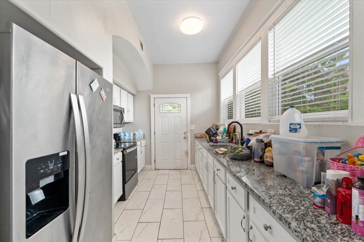 196 North McNeil Street Memphis, TN 38112 - Photo 24 of 31 a kitchen with stainless steel appliances granite countertop a refrigerator and a sink