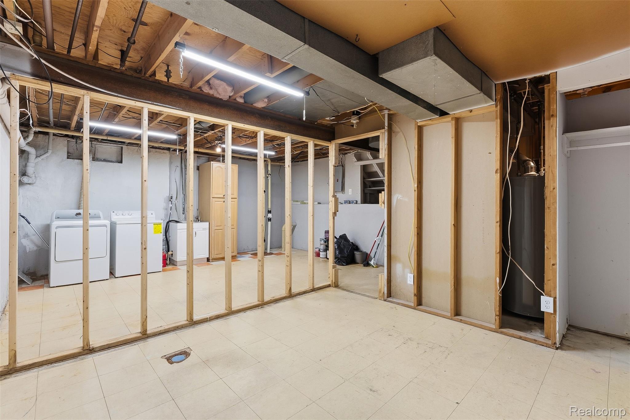 819 Alpine Trail Fenton, MI 48430 - Photo 31 of 41 Unfinished basement area featuring framed partition walls, exposed ceiling joists, and a utility sink