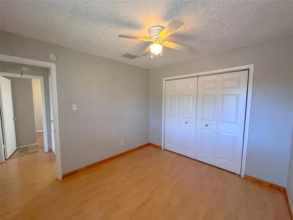 a view of an empty room with a fan
