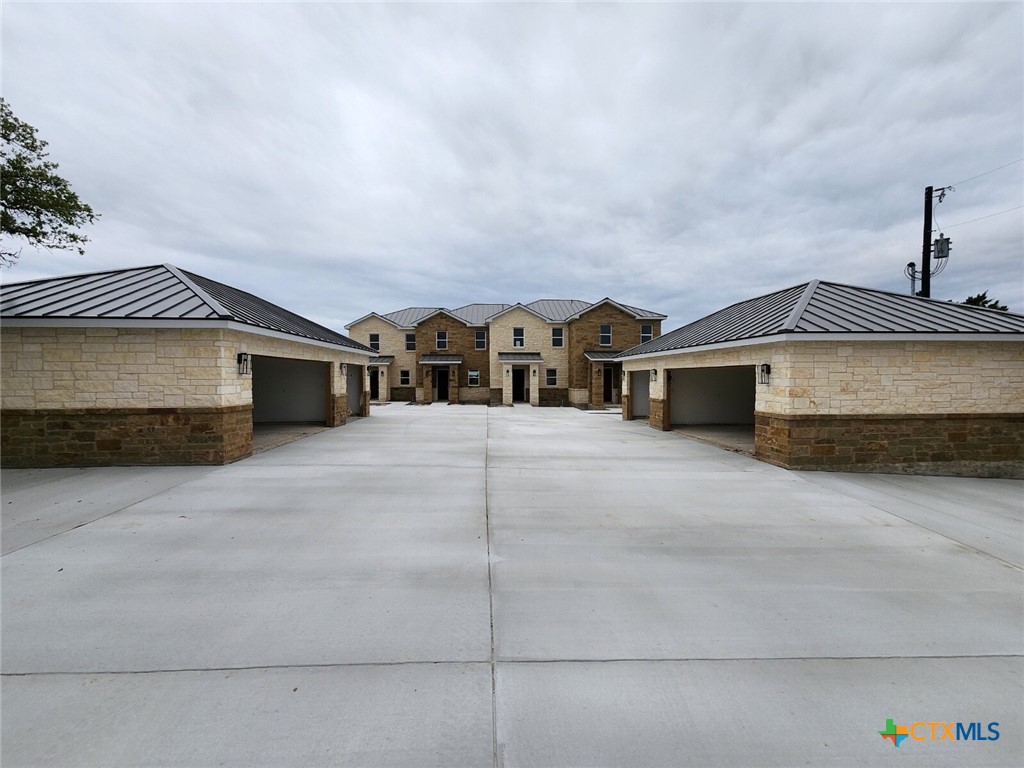 289 Star Grass, Unit 3 Spring Branch, TX 78070 - Photo 32 of 40 a front view of a house with a garage
