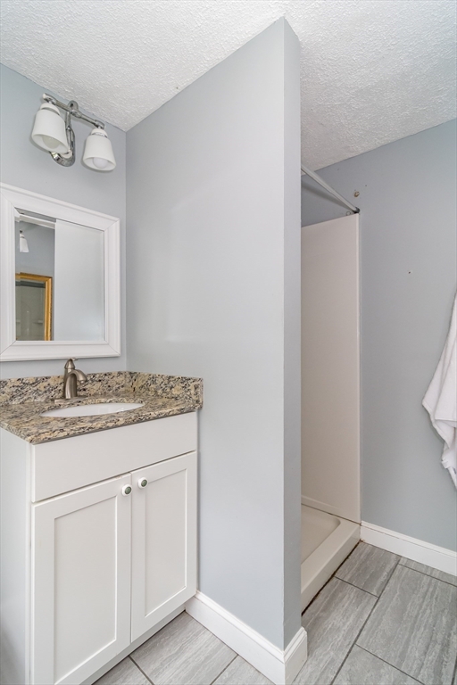 14 Wedgewood Road Natick, MA 01760 - Photo 25 of 28 a bathroom with a granite countertop sink and a mirror