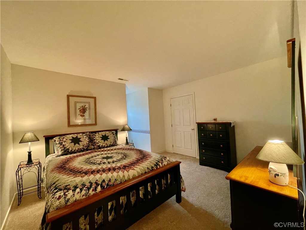 1751 Evans Mill Road Dillwyn, VA 23936 - Photo 31 of 50 a bedroom with a bed and a lamp