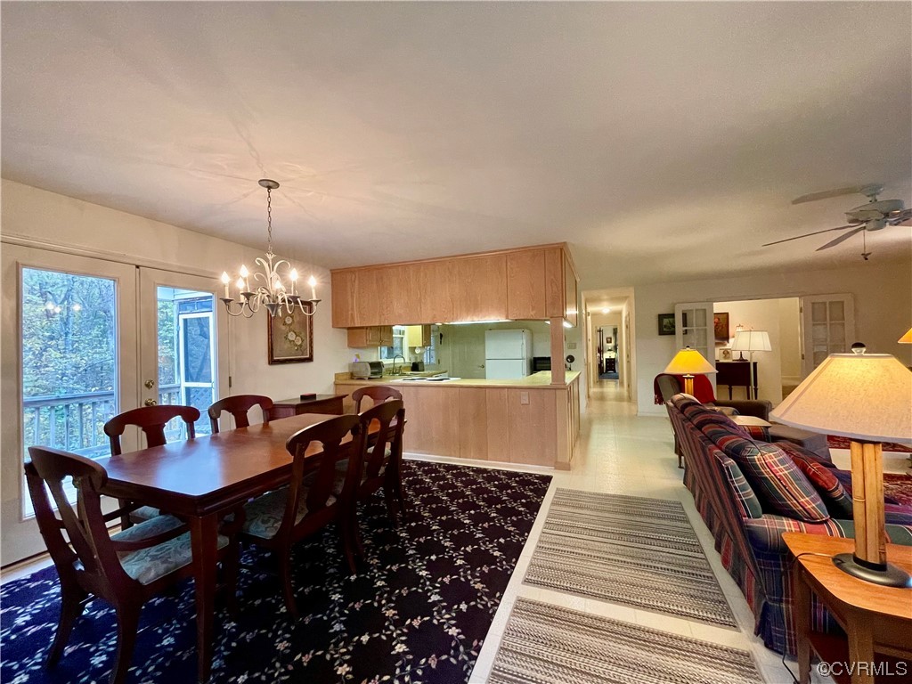 1751 Evans Mill Road Dillwyn, VA 23936 - Photo 7 of 50 a dining room with wooden floor a chandelier a wooden table and chairs
