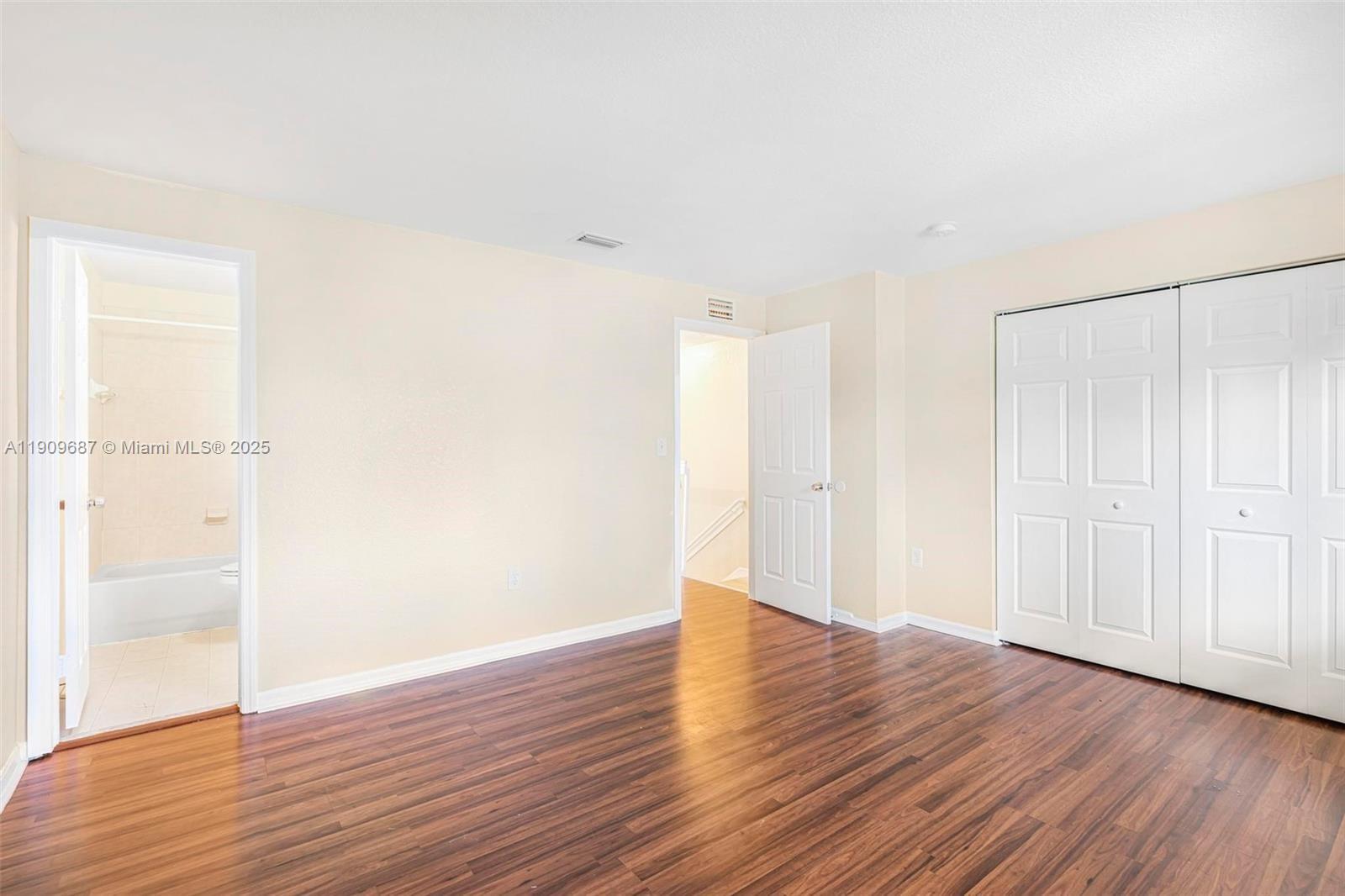 2261 Northwest 136th Terrace, Unit 2261 Opa-Locka, FL 33054 - Photo 12 of 19 a view of an empty room with wooden floor