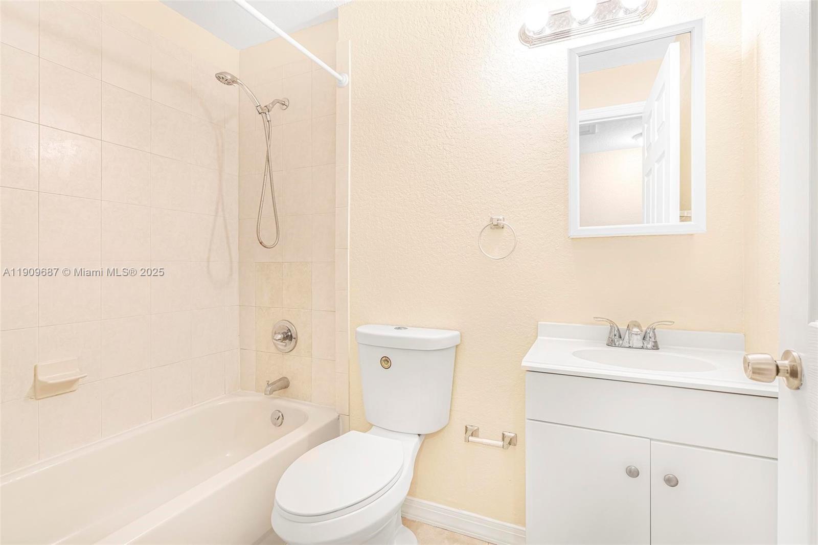 2261 Northwest 136th Terrace, Unit 2261 Opa-Locka, FL 33054 - Photo 16 of 19 a bathroom with a sink toilet and shower