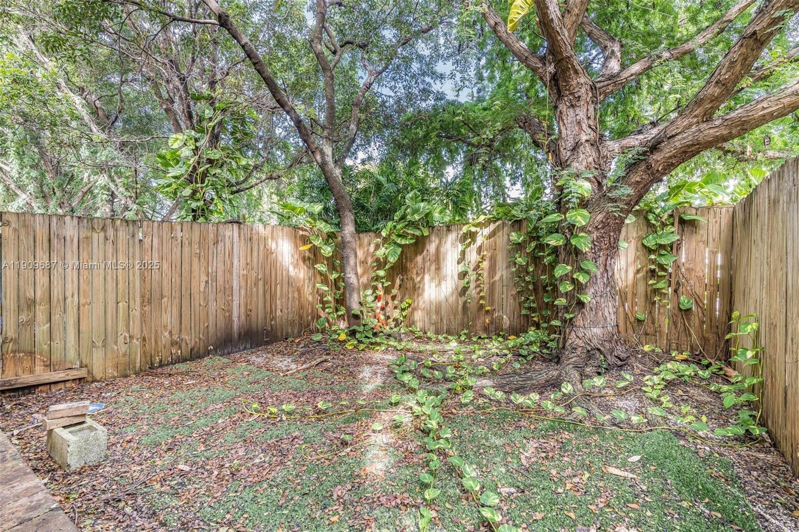 2261 Northwest 136th Terrace, Unit 2261 Opa-Locka, FL 33054 - Photo 18 of 19 a view of backyard with tree