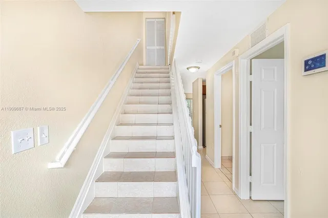 a view of staircase with white walls