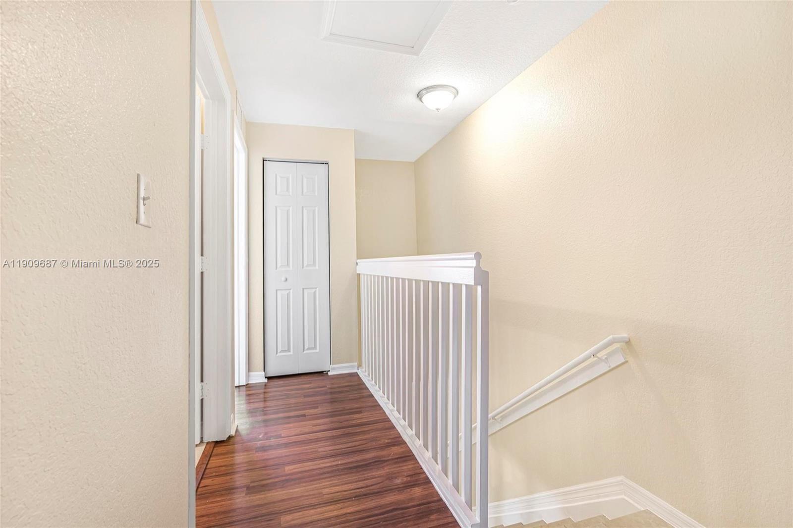 2261 Northwest 136th Terrace, Unit 2261 Opa-Locka, FL 33054 - Photo 10 of 19 a view of a hallway with wooden floor