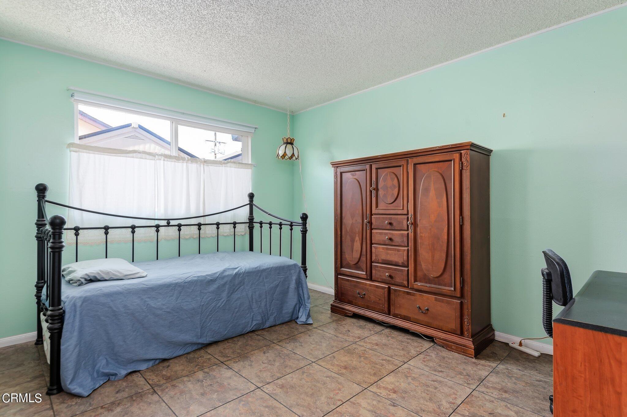4810 Del Oro Place Oxnard, CA 93033 - Photo 13 of 21 a bed sitting in a bedroom next to a window