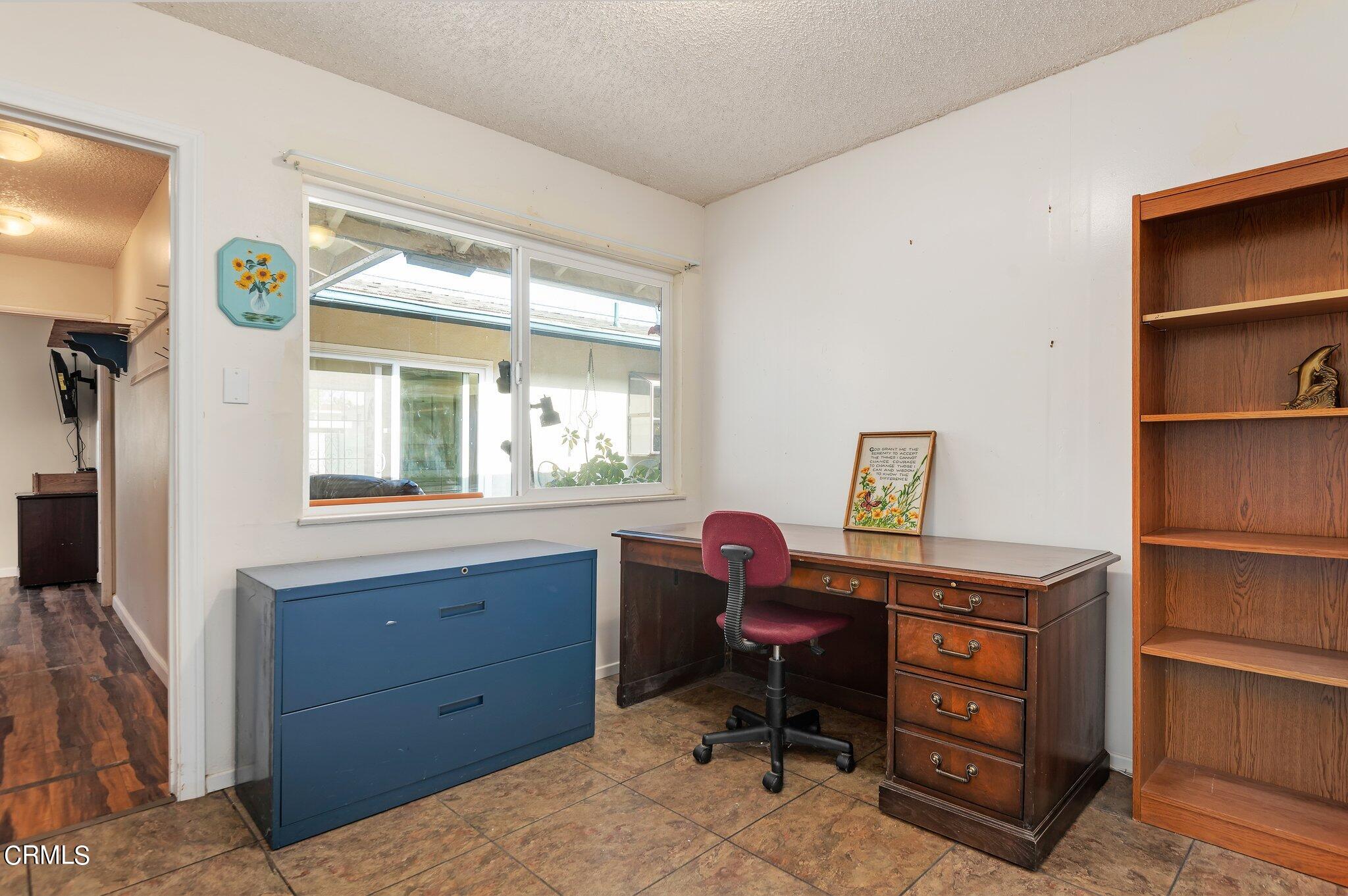4810 Del Oro Place Oxnard, CA 93033 - Photo 15 of 21 a view of a workspace with furniture and a window