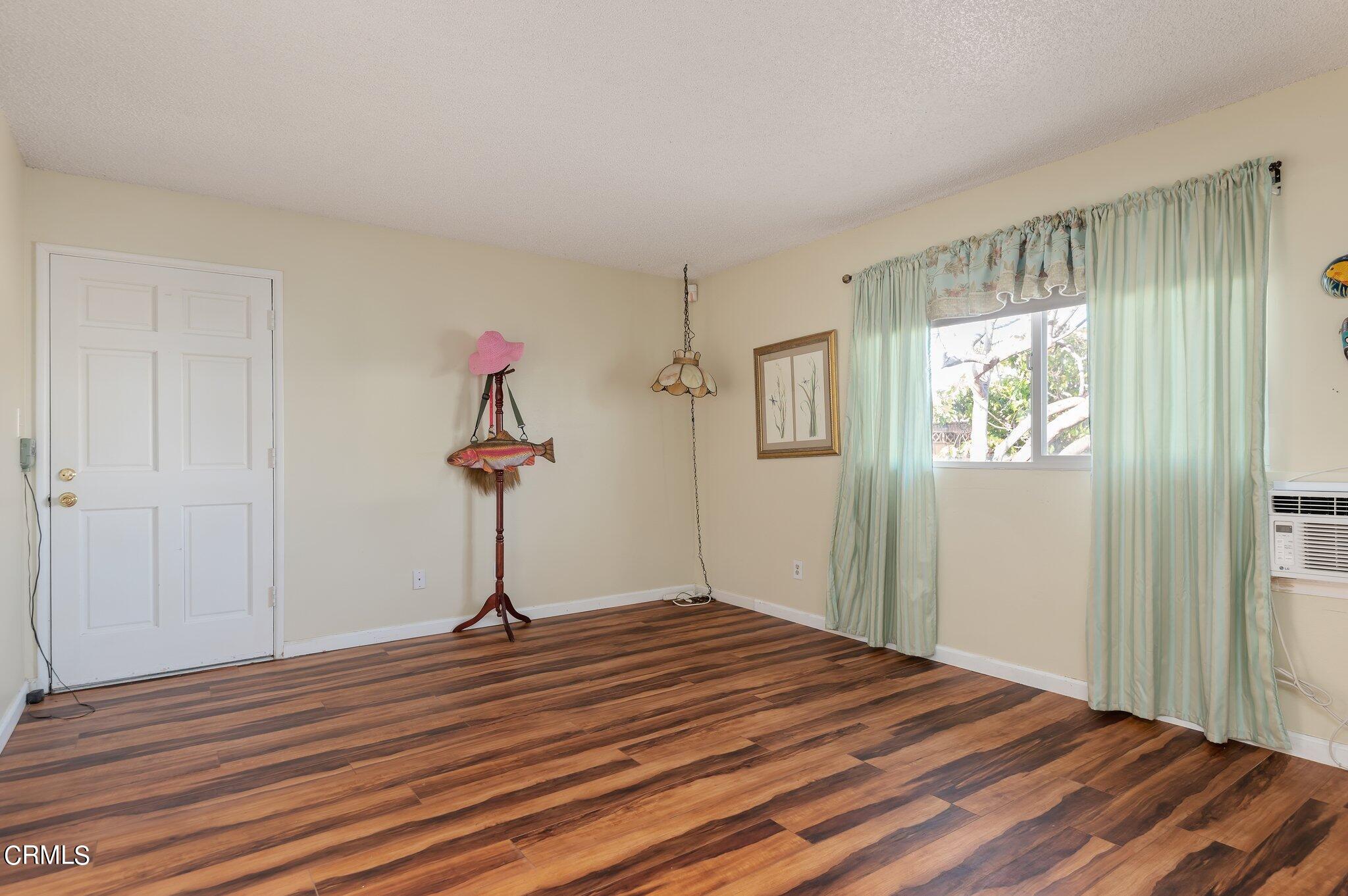 4810 Del Oro Place Oxnard, CA 93033 - Photo 20 of 21 a view of a livingroom with wooden floor and a ceiling fan