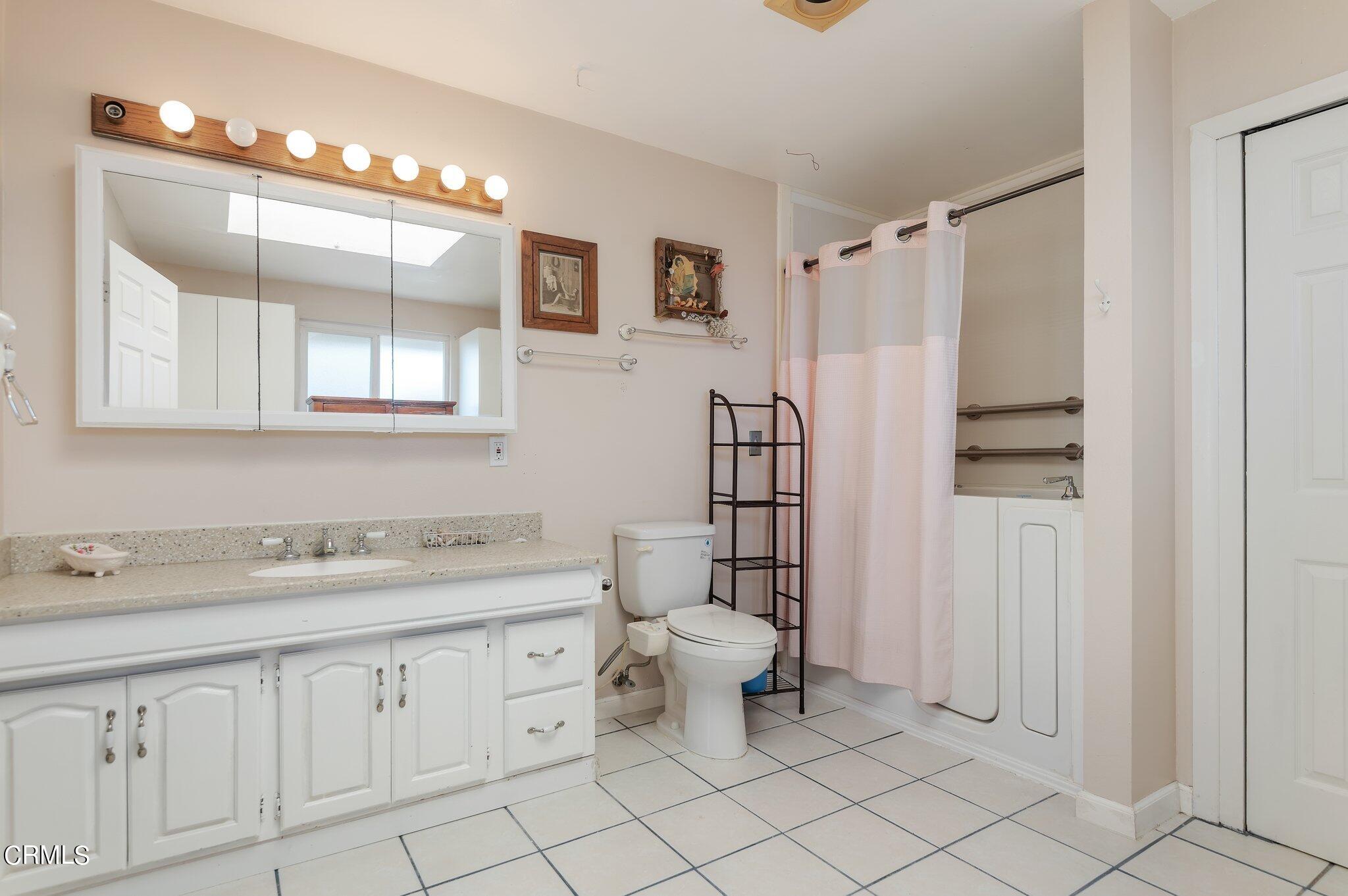 4810 Del Oro Place Oxnard, CA 93033 - Photo 21 of 21 a bathroom with a sink vanity and mirror