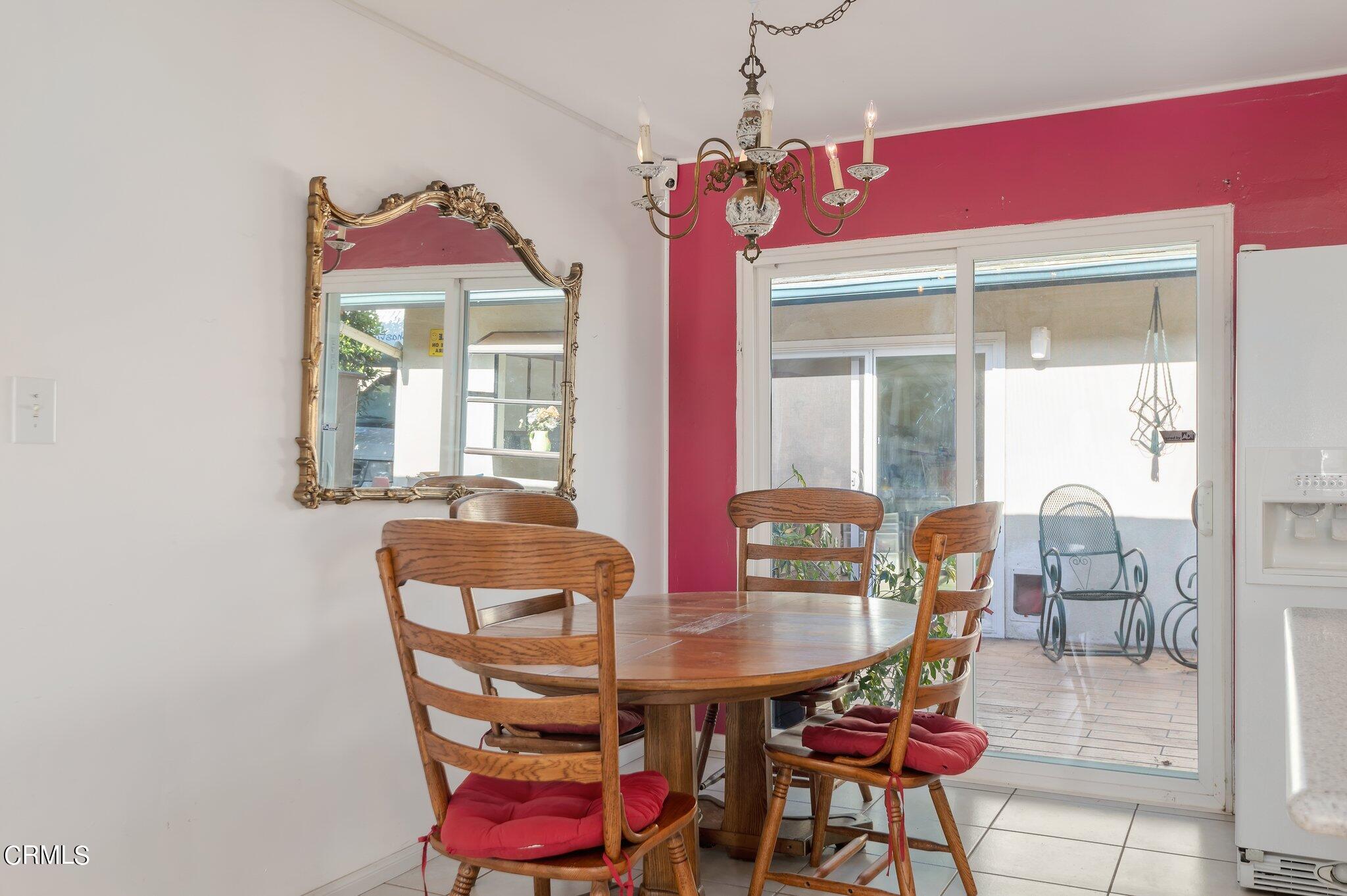 4810 Del Oro Place Oxnard, CA 93033 - Photo 7 of 21 a view of a dining room with furniture and a chandelier