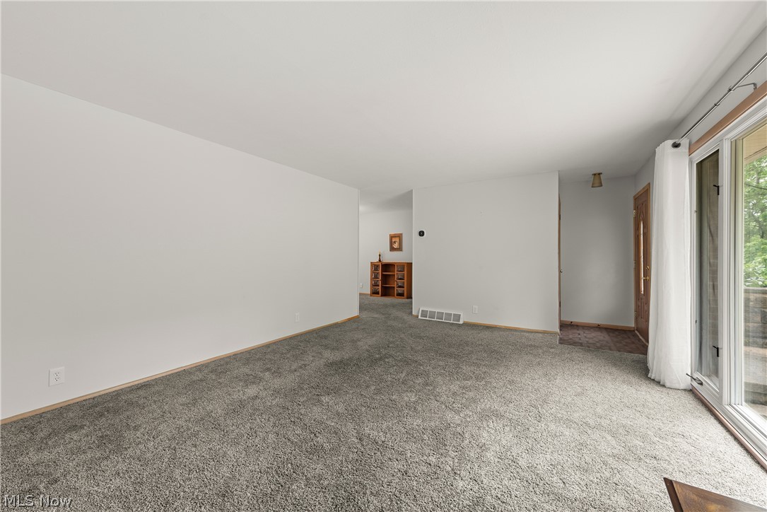 Unfurnished living room with carpet floors