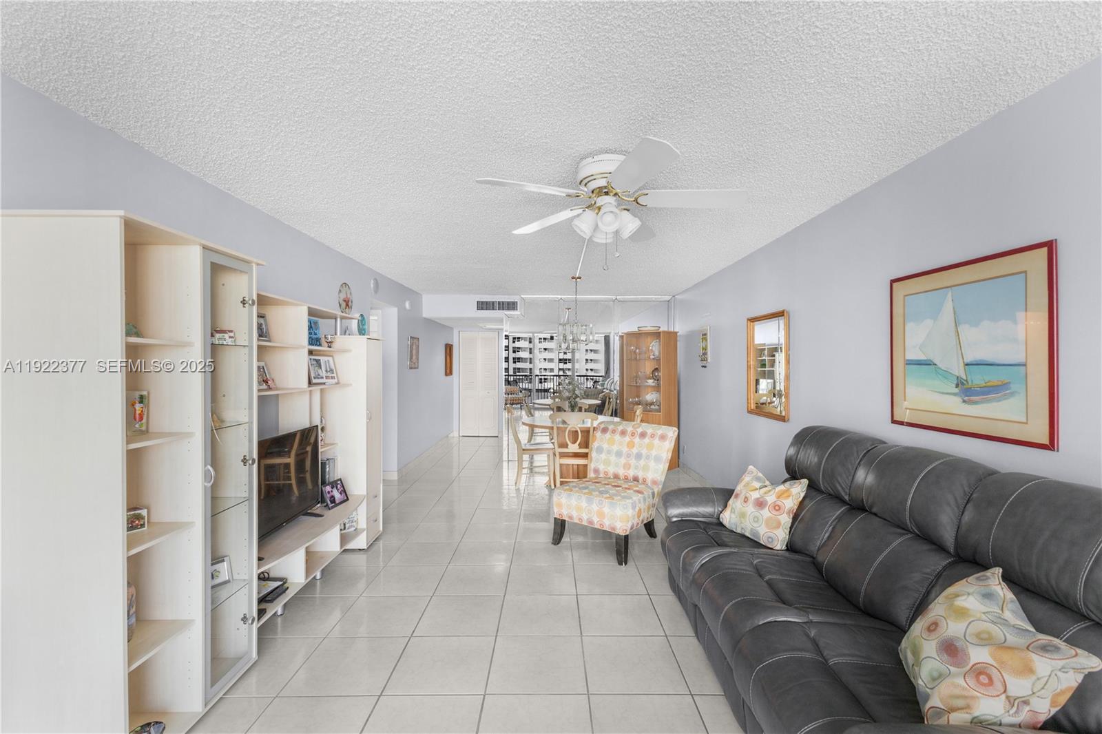 2655 Collins Avenue, Unit 603 Miami Beach, FL 33140 - Photo 13 of 66 a living room with furniture and a chandelier
