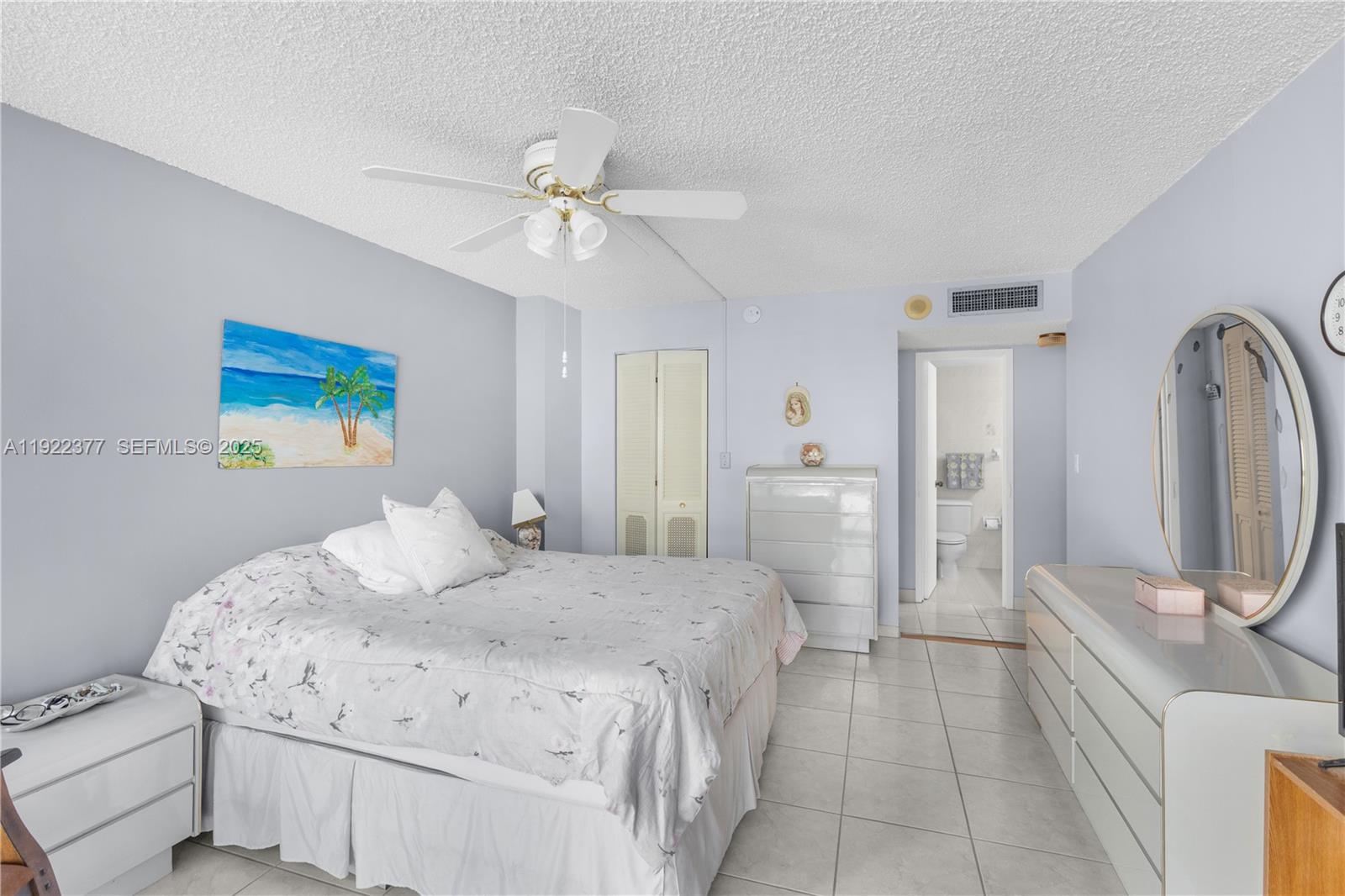 2655 Collins Avenue, Unit 603 Miami Beach, FL 33140 - Photo 34 of 66 a bedroom with a bed and a chandelier