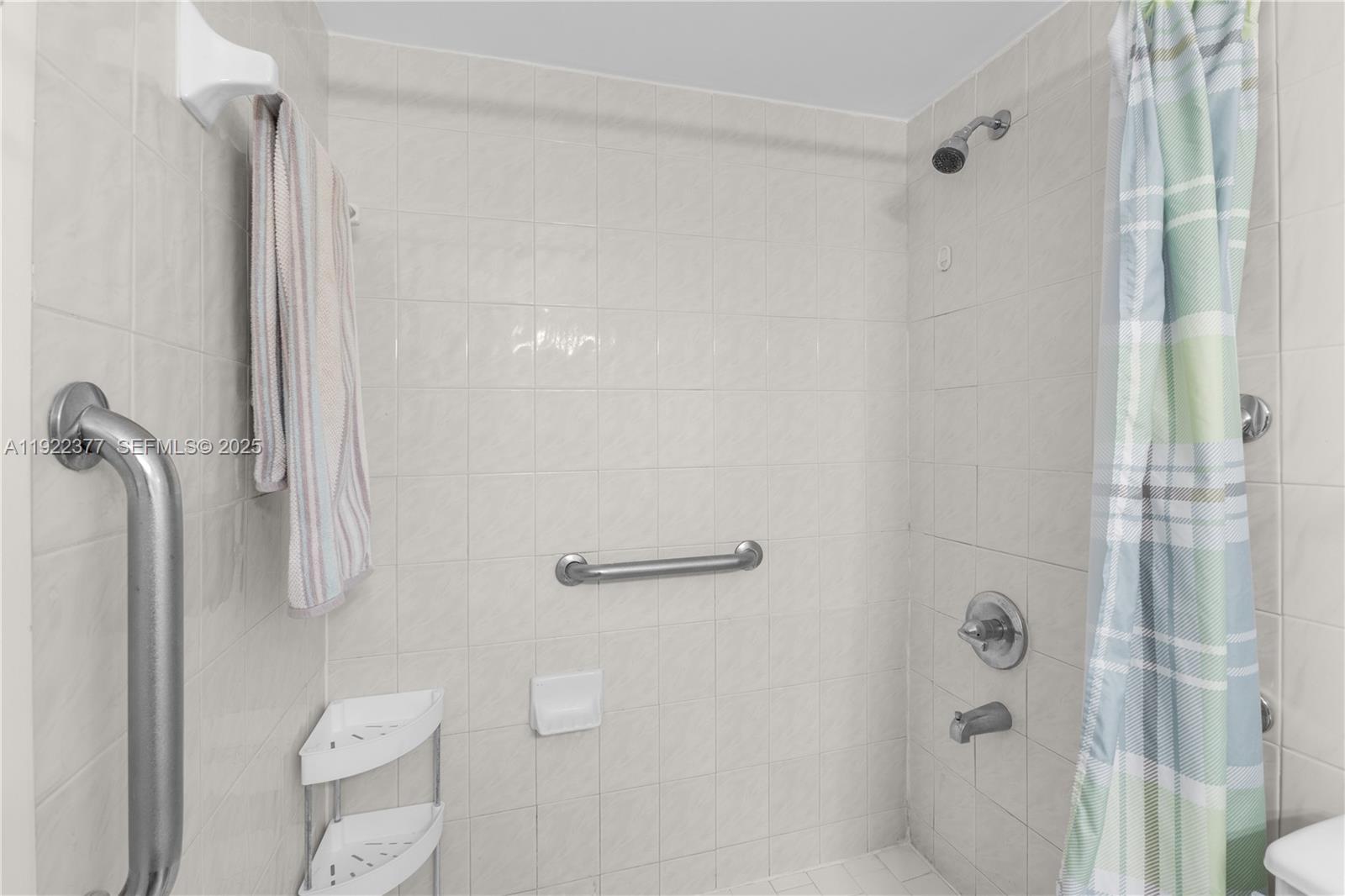 2655 Collins Avenue, Unit 603 Miami Beach, FL 33140 - Photo 36 of 66 a bathroom with a shower and toilet