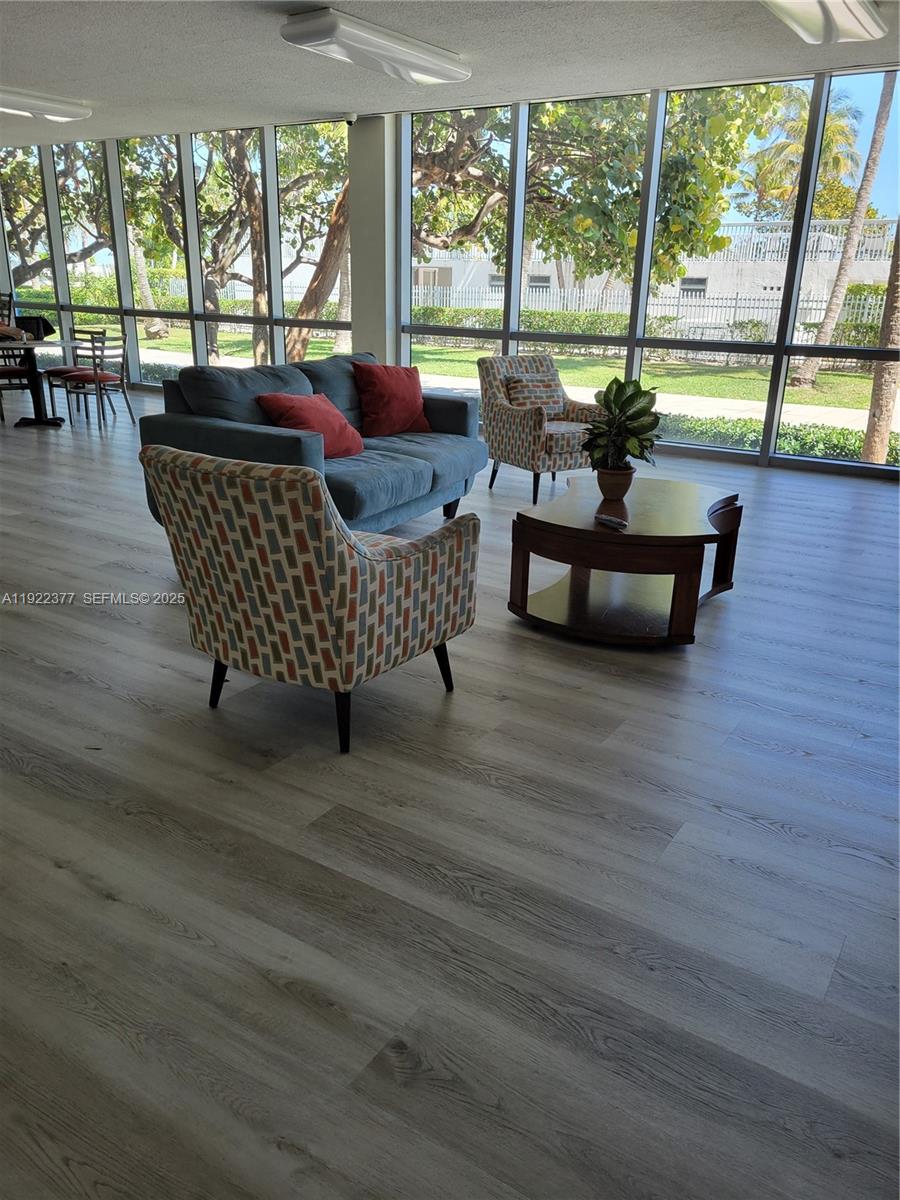 2655 Collins Avenue, Unit 603 Miami Beach, FL 33140 - Photo 42 of 66 a living room with furniture and a floor to ceiling window