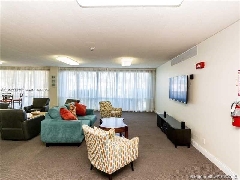 2655 Collins Avenue, Unit 603 Miami Beach, FL 33140 - Photo 43 of 66 a living room with furniture and a window