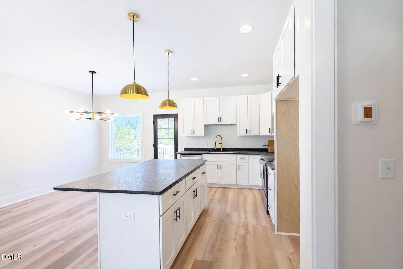 390 Park Springs Road Providence, NC 27315 - Photo 6 of 14 a kitchen with stainless steel appliances granite countertop a sink a refrigerator and a stove