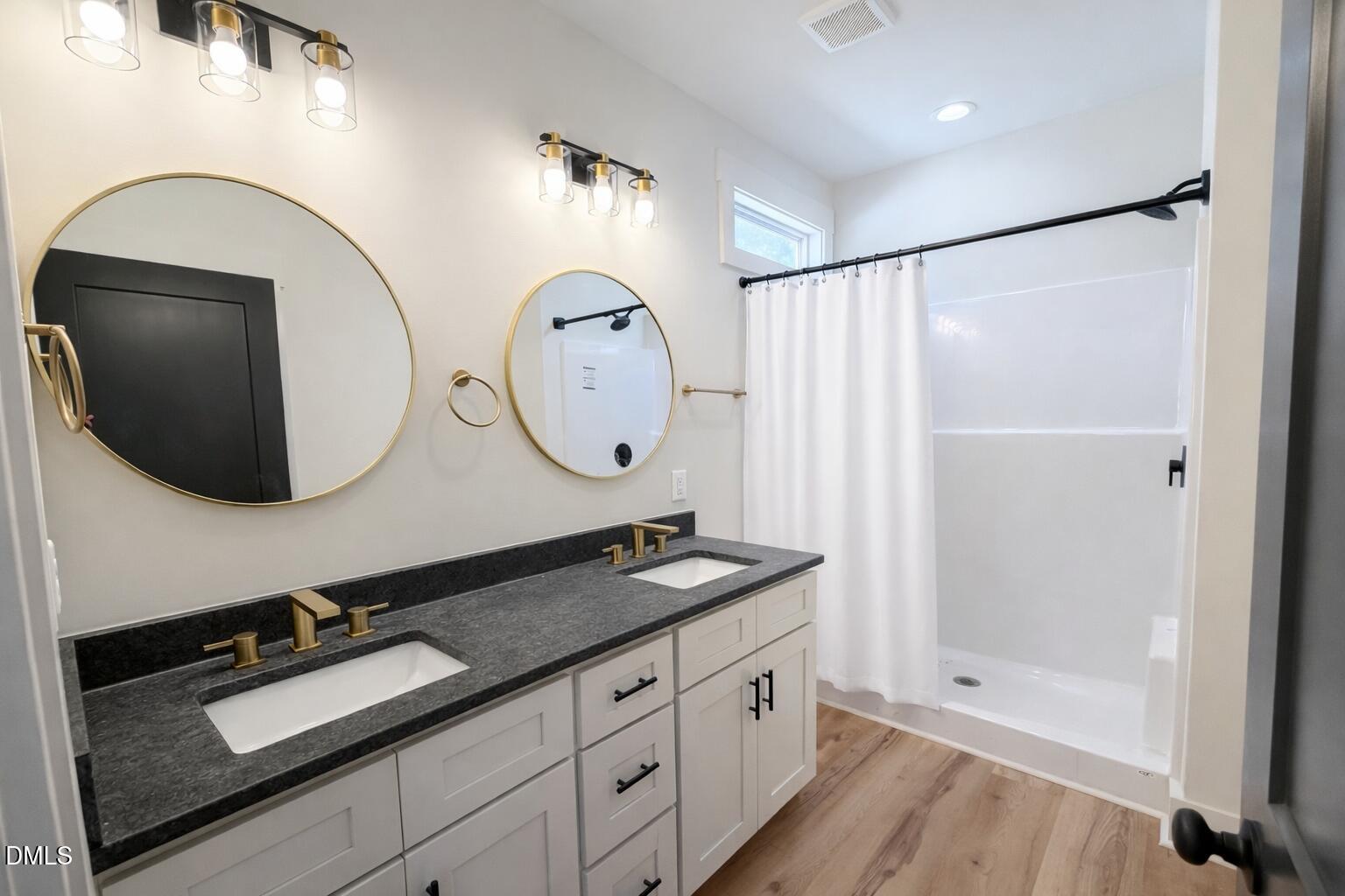 390 Park Springs Road Providence, NC 27315 - Photo 8 of 14 a bathroom with a granite countertop sink mirror and vanity