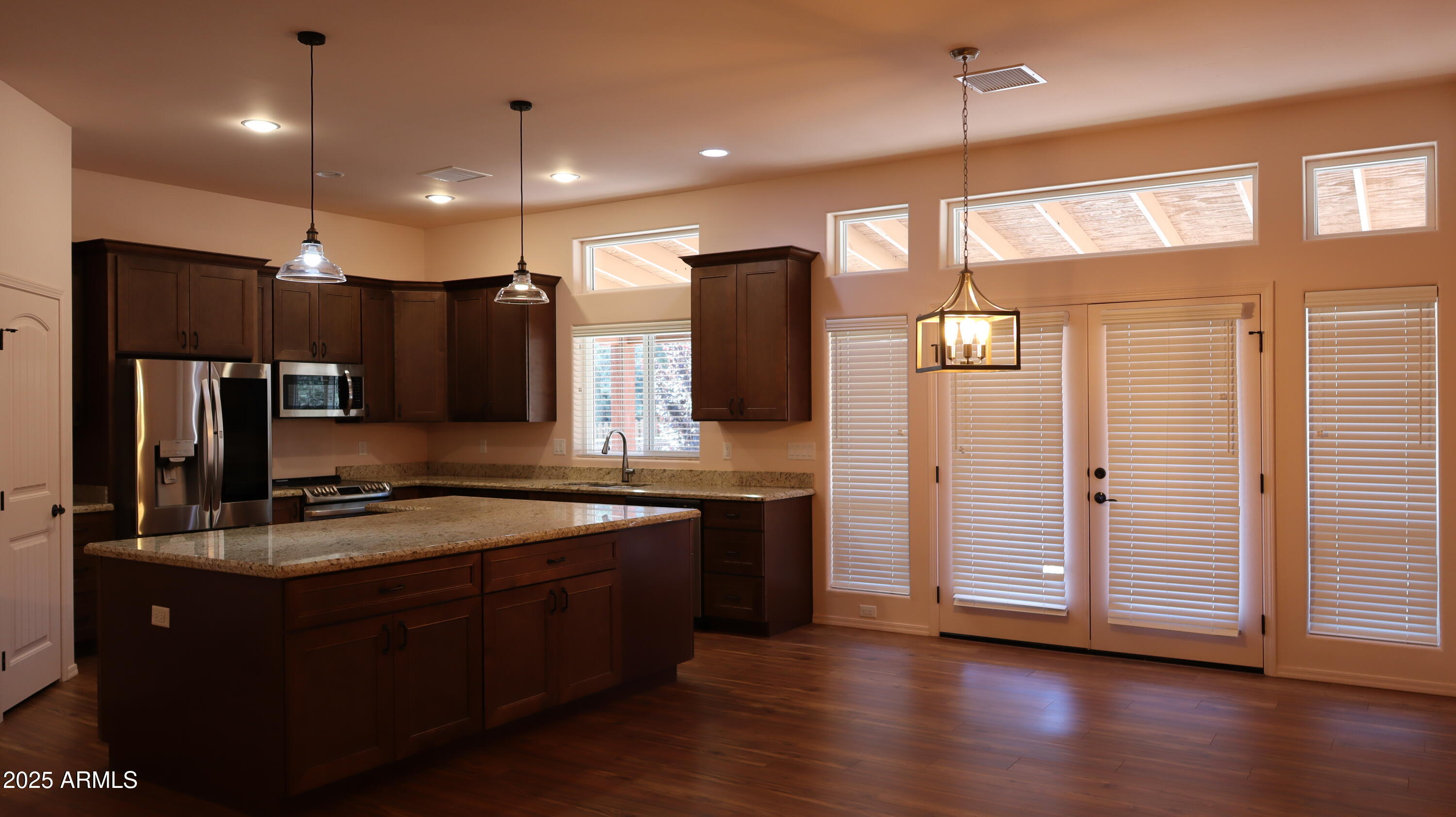 1701 West Dillon Way Payson, AZ 85541 - Photo 22 of 83 a kitchen with stainless steel appliances granite countertop a refrigerator a sink and wooden floor