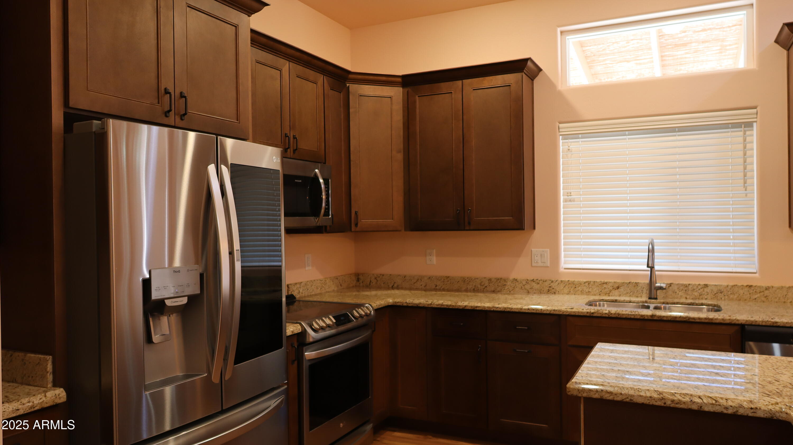 1701 West Dillon Way Payson, AZ 85541 - Photo 27 of 83 a kitchen with granite countertop a refrigerator and a sink