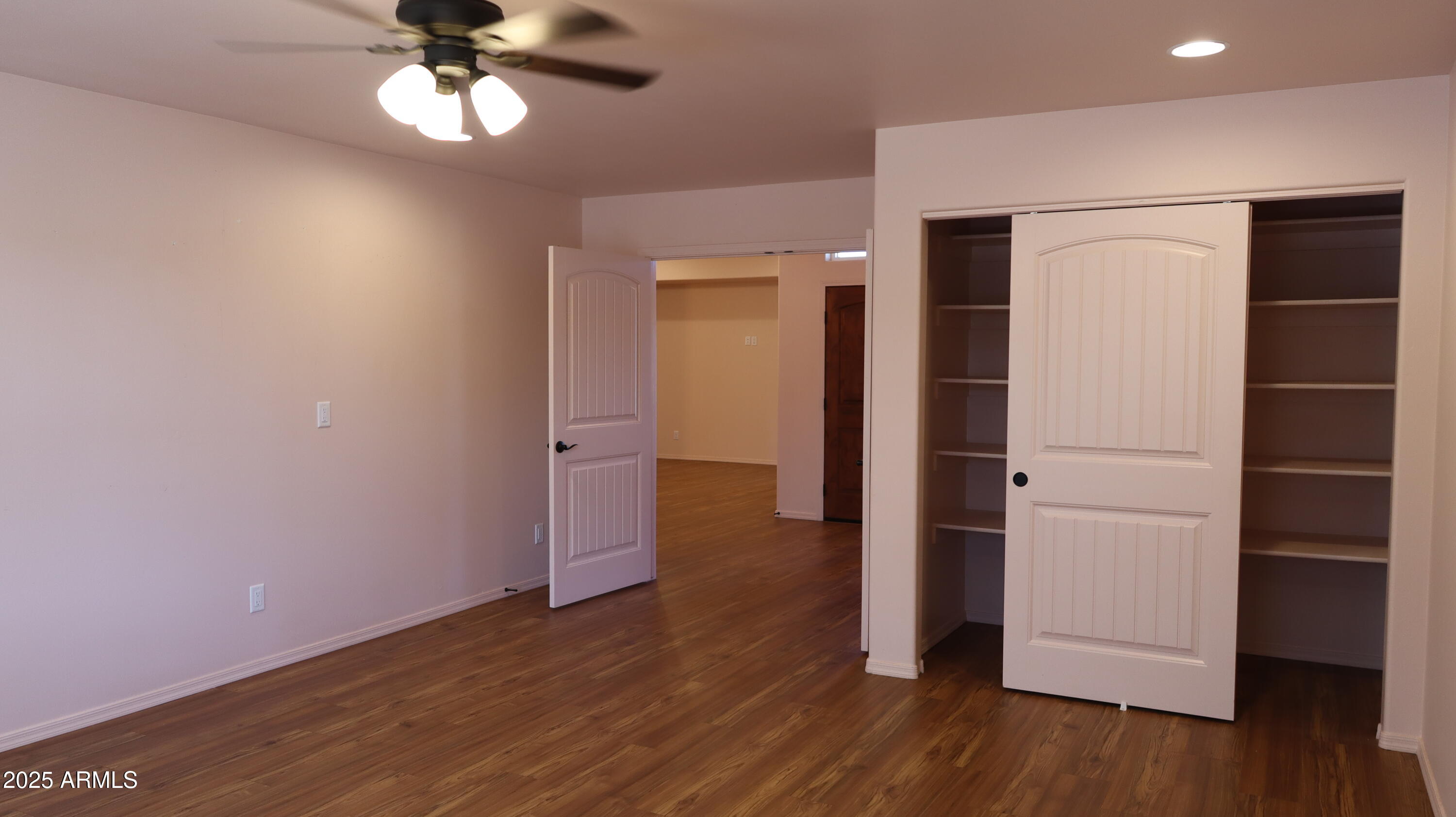 1701 West Dillon Way Payson, AZ 85541 - Photo 32 of 83 an empty room with wooden floor closet and windows