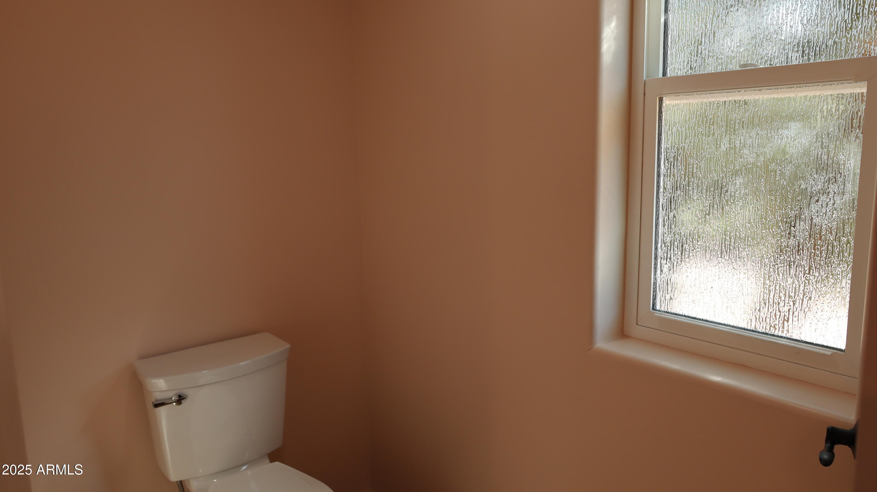 1701 West Dillon Way Payson, AZ 85541 - Photo 43 of 83 a white toilet sitting in a bathroom next to a window