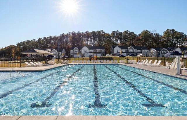 a view of a swimming pool with an outdoor seating and a garden