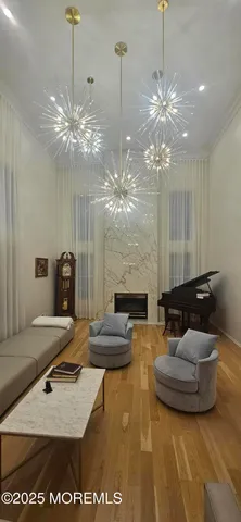 a living room with furniture and a chandelier