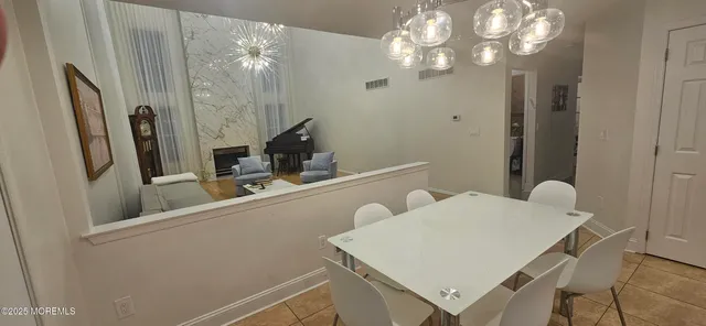 a view of a room with furniture and wooden floor