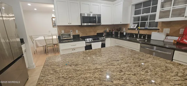 a view of staircase with white walls and a window