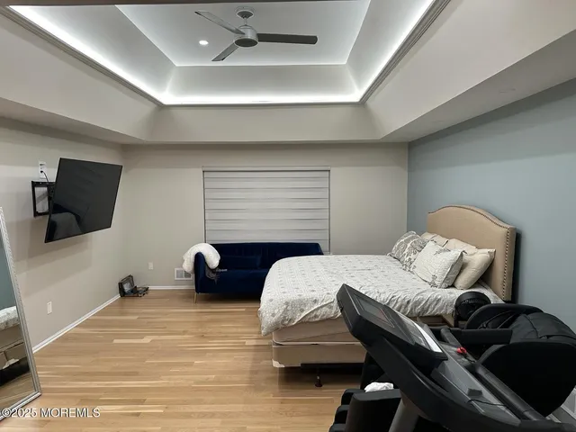 a bedroom with furniture and a flat screen tv
