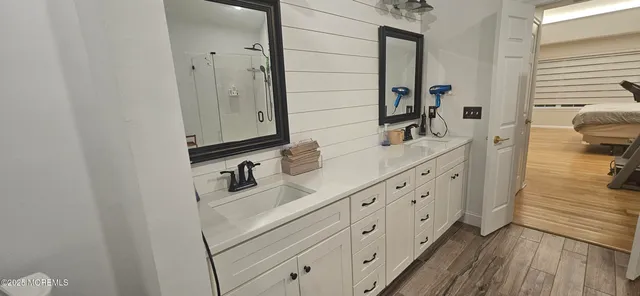 a bathroom with a sink a toilet and mirror