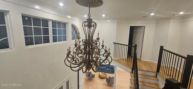 a bedroom with two beds and a chandelier