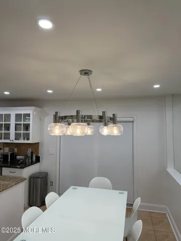 a dining room with furniture and a chandelier
