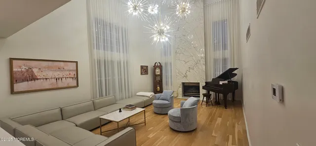a living room with furniture and a chandelier