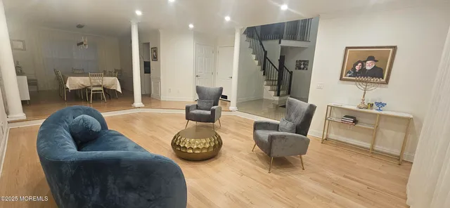 a living room with furniture and a wooden floor