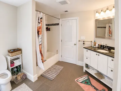 a spacious bathroom with a double vanity sink and a mirror